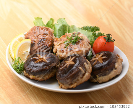 A classic mushroom dish: Shiitake stuffed with meat, served with tomatoes, lemon parsley, and shiso leaves. A classic mushroom dish: Shiitake stuffed with meat, served with tomatoes, lemon parsley, and shiso leaves. 108453932