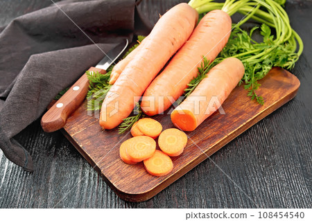 Carrots fresh on dark board 108454540