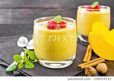 Dessert of yogurt and and pumpkin in glass on dark board 108454552