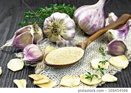 Garlic ground in spoon on wooden board Garlic ground in spoon on wooden board 108454566
