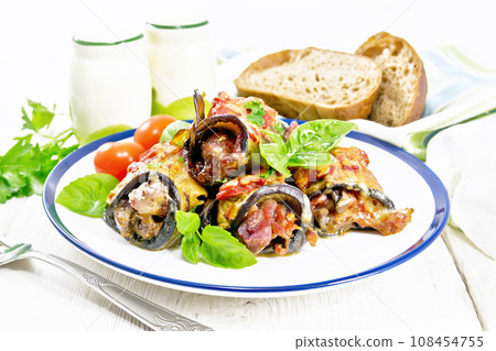 Rolls of eggplant with meat in plate on board Rolls of eggplant with meat in plate on board 108454755