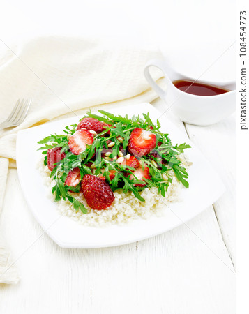 Salad of strawberry and couscous on light wooden board Salad of strawberry and couscous on light wooden board 108454773