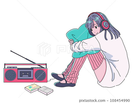 A girl listening to music from a cassette tape on a radio cassette player 108454990