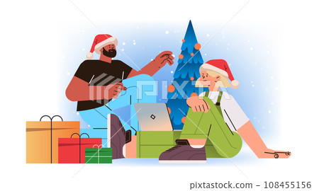 mix race man woman in santa hats near decorated christmas tree using laptop social media communication new year holidays celebration concept mix race man woman in santa hats near decorated christmas tree using laptop social media communication new year holidays celebration concept 108455156