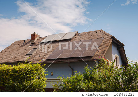 Solar photovoltaic panels on house roof. Modern country house with self-sustaining energy system. Suburb of Vienna, Austria. Idea harnessing clean and sustainable energy, saving money on electricity 108455225