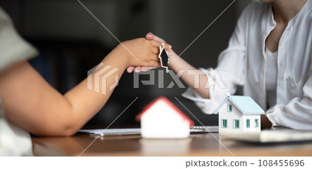 The bank mortgage officer or real estate agent handshake with customer deal after signing a house insurance, loan contract agreement The bank mortgage officer or real estate agent handshake with customer deal after signing a house insurance, loan contract agreement 108455696