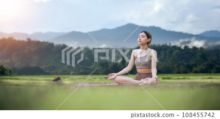 Asian woman on fitness mat, sporty lady practicing yoga at public park outdoor, stretching her body. Healthy active lifestyle Asian woman on fitness mat, sporty lady practicing yoga at public park outdoor, stretching her body. Healthy active lifestyle 108455742