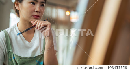 hand of artist with brush painting picture art, creativity, artistic and artwork, painting, Colorful artist brushes and paint palette concept 108455758