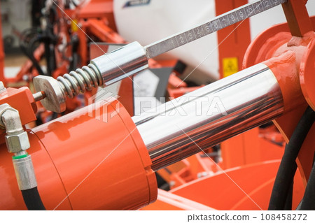 Red piston or actuator in pneumatic or hydraulic machine. Technology 108458272