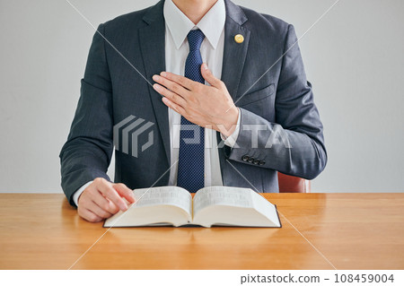 Male lawyer putting his hand on his chest Male lawyer putting his hand on his chest 108459004