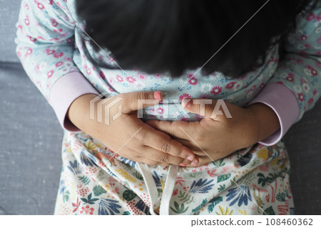 child suffering stomach pain close up. child suffering stomach pain close up. 108460362