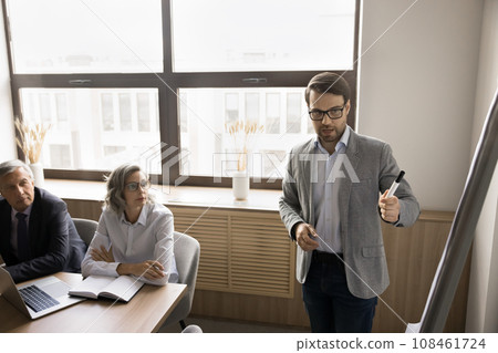 Serious young businessman presenting startup project plan to business partners 108461724