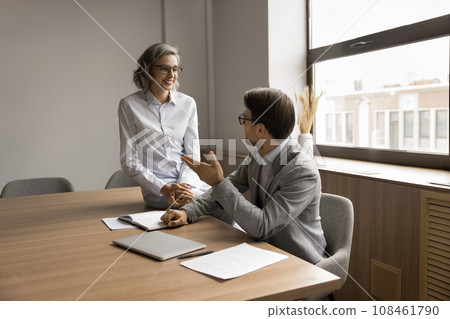 Two project managers discussing project ideas, brainstorming at meeting table 108461790
