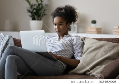 Happy Black student girl studying from home Happy Black student girl studying from home 108462006