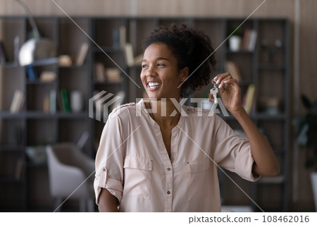 Happy excited millennial Black woman getting keys from new home 108462016