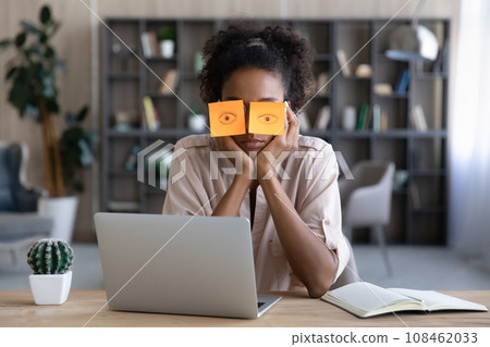 Tired Afro American millennial student girl sleeping at workplace 108462033