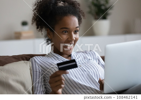 Happy surprised Black shopper girl excited with sale, special offer 108462141