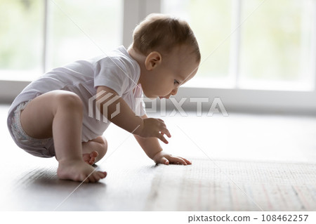 Cute little baby tries to make first steps 108462257