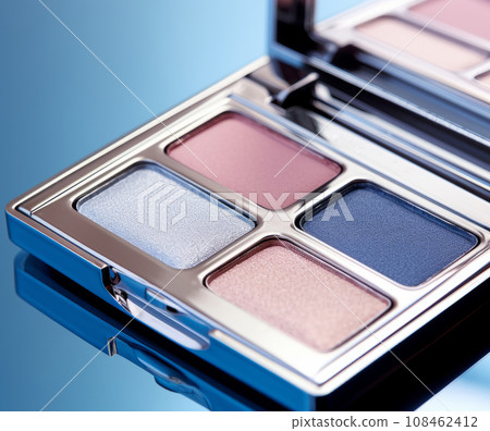 A close-up of pearlescent shimmery palette of blue eyeshadows for creating eye makeup.  108462412