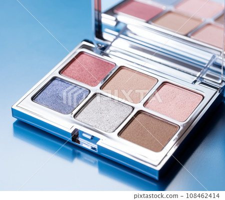 A close-up of pearlescent shimmery palette of blue eyeshadows for creating eye makeup.  108462414