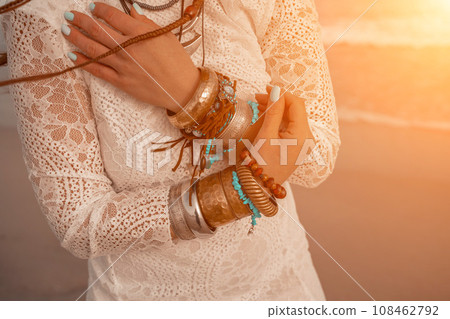Model in boho style in a white long dress and silver jewelry on Model in boho style in a white long dress and silver jewelry on 108462792