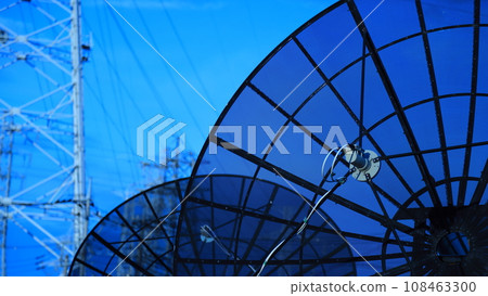 Parabolic antenna, blue sky and power line tower - image material for electronic communication and electricity 108463300