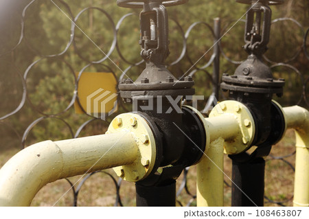 Yellow gas pipes and valves outdoors. gas equipment. Copy space for text. High quality photo Yellow gas pipes and valves outdoors. gas equipment. Copy space for text. High quality photo 108463807