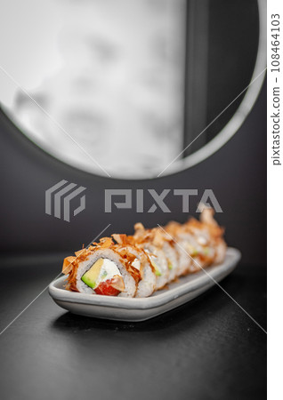 Classic Bonito sushi roll set with tuna flakes, salmon and avocado. 108464103