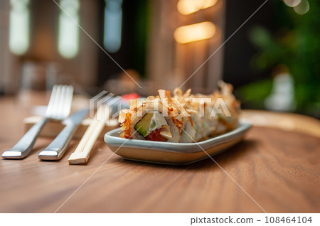 Classic Bonito sushi roll set with tuna flakes, salmon and avocado. 108464104