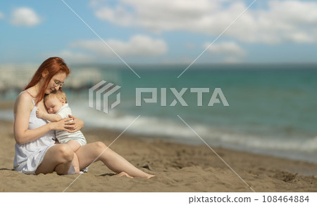 Happy mother and her little son resting on the seaside - hugging 108464884