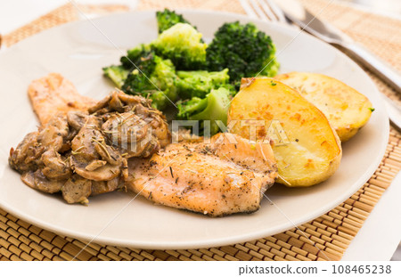 Fried river trout fillet with a complex side dish of broccoli, baked potatoes and mushroom sauce Fried river trout fillet with a complex side dish of broccoli, baked potatoes and mushroom sauce 108465238