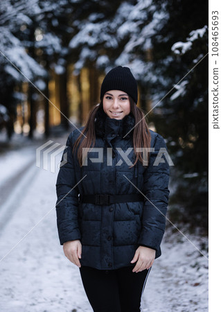 Portrait of attractive young woman in winter forest. Christas mood Portrait of attractive young woman in winter forest. Christas mood 108465693