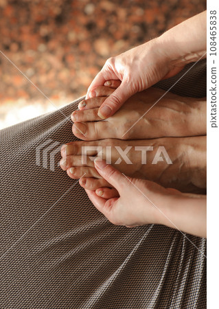 Female showing feet with subungual hematoma, black toenails caused by trauma, fungal infection or chemotherapy. Person suffering from onychomycosis, a fungal infection causing yellowing of the toenail 108465838