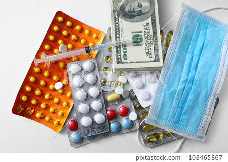 medicine mask, money, dollars banknote, red pills and syringe on white background, medical expense concept. Concept of expensive health care. Chinese coronavirus covid-19 outbreak concept. medicine mask, money, dollars banknote, red pills and syringe on white background, medical expense concept. Concept of expensive health care. Chinese coronavirus covid-19 outbreak concept. 108465867
