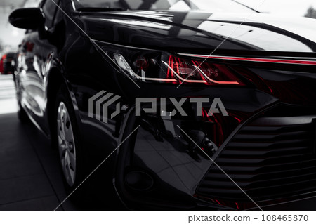 headlight of modern prestigious black car close up. Close up photo of modern car, detail of headlight. Headlight car Projector LED of a modern luxury technology and auto detail. selective focus headlight of modern prestigious black car close up. Close up photo of modern car, detail of headlight. Headlight car Projector LED of a modern luxury technology and auto detail. selective focus 108465870