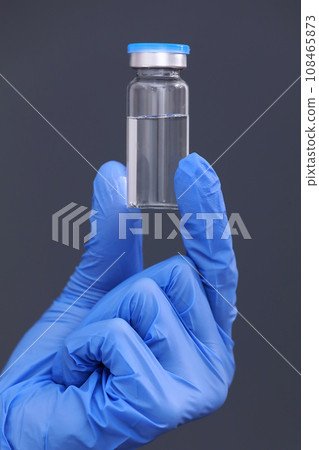 Development and creation of a coronavirus vaccine COVID-19 .Coronavirus Vaccine in glass bottle in hand of doctor on gray background. Vaccine Concept of fight against coronavirus. Development and creation of a coronavirus vaccine COVID-19 .Coronavirus Vaccine in glass bottle in hand of doctor on gray background. Vaccine Concept of fight against coronavirus. 108465873