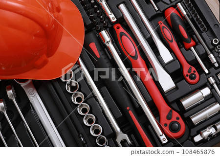 Toolbox, tools kit detail and orange protective helmet close up. instruments. set of tools. car tool kit. tool set background. instruments for repair. Toolbox, tools kit detail and orange protective helmet close up. instruments. set of tools. car tool kit. tool set background. instruments for repair. 108465876