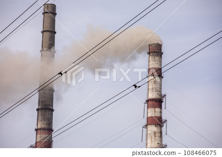 Smoke from two industrial chimneys, pipes, against the sky. Global warming. Air pollution. Ecological pollution. Air emissions polluting the city. Industrial waste is hazardous to health. 108466075