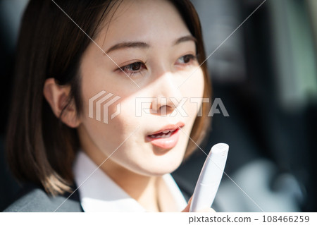 Young female driver recording alcohol test results before driving 108466259