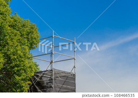 Blue sky, trees and rolling tower 108466535