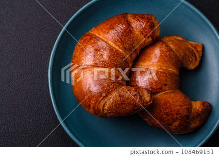 Delicious baked crispy croissants as an element of an invigorating, nutritious breakfast Delicious baked crispy croissants as an element of an invigorating, nutritious breakfast 108469131