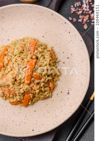 Delicious Uzbek pilaf with chicken, carrots, barberry, spices and herbs 108469151