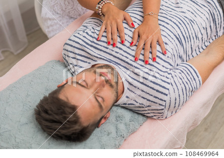 The healer performs the access bars therapy and touching to 32 points for healing his body, an alternative medicine concept The healer performs the access bars therapy and touching to 32 points for healing his body, an alternative medicine concept 108469964