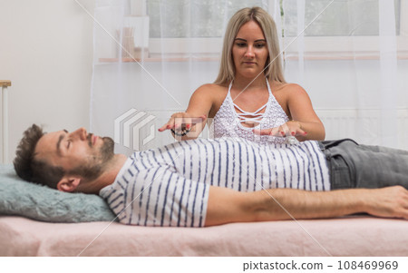 The healer performs the access bars therapy and touching to 32 points for healing his body, an alternative medicine concept 108469969