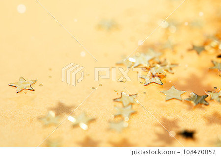 Golden stars scatter and glitter sparking. Blinking confetti celebration on yellow background. Glowing yellow backdrop. Golden stars scatter and glitter sparking. Blinking confetti celebration on yellow background. Glowing yellow backdrop. 108470052