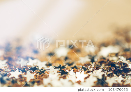 Vintage Christmas Decoration With Stars And Lights. Gold festive background with shining golden confetti stars. Vintage Christmas Decoration With Stars And Lights. Gold festive background with shining golden confetti stars. 108470053