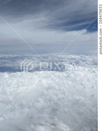 Taking pictures of the clouds outside the window while flying Taking pictures of the clouds outside the window while flying 108470653