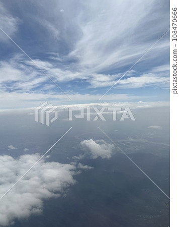 Taking pictures of the clouds outside the window while flying 108470666