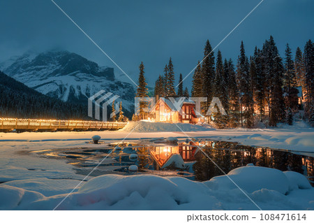 Emerald Lake with snow covered and wooden lodge glowing in pine forest on winter at Yoho national park, Canada 108471614