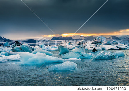 Jokulsarlon glacier lagoon with blue iceberg melting during summer in the evening at Vatnajokull national park, Iceland Jokulsarlon glacier lagoon with blue iceberg melting during summer in the evening at Vatnajokull national park, Iceland 108471630